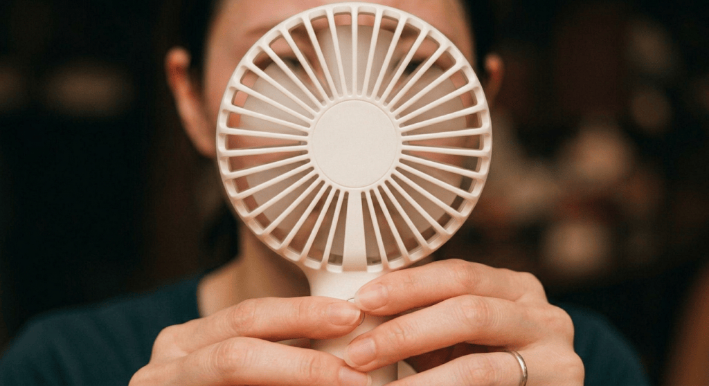 Large foreground fan with unseen woman